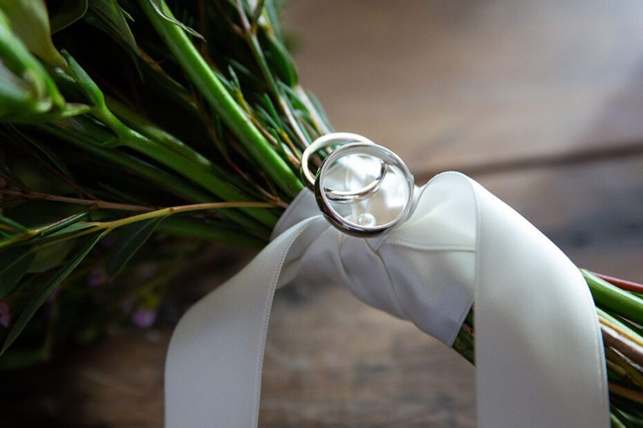 The wedding rings placed on the bouquet