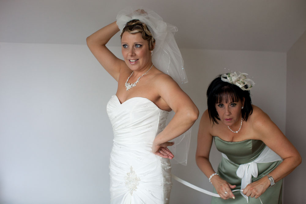 Bride holds her veil up