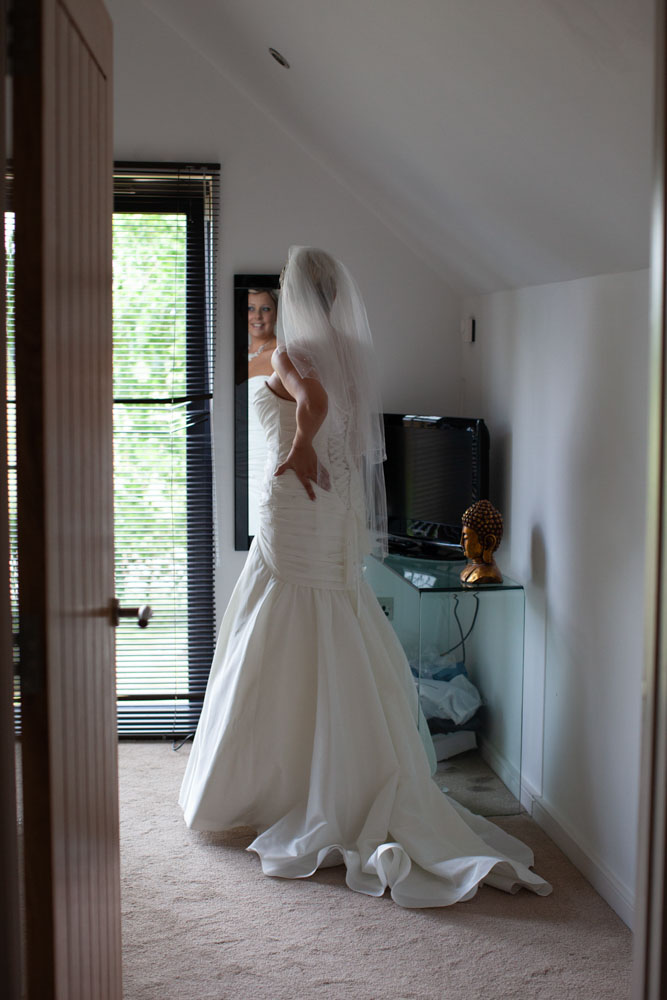 Bride poses by the mirror