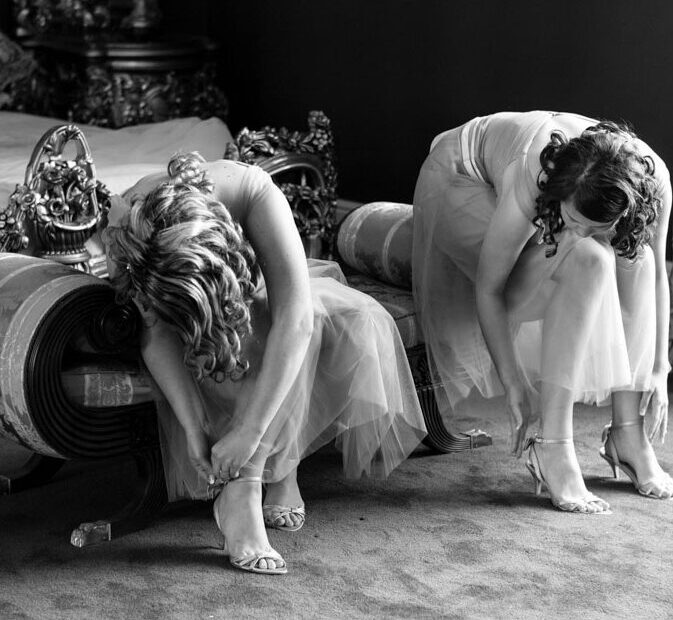 Bridesmaids fastening their shoes