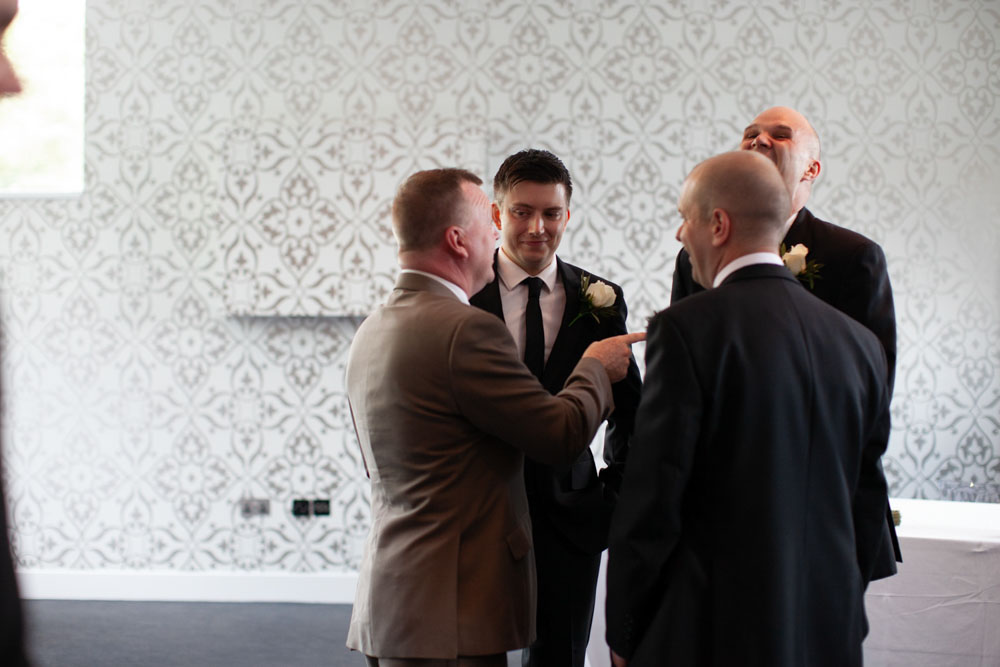 The groom smiles