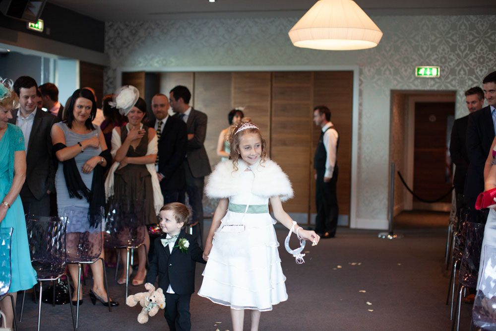 Bridesmaid and pageboy walk in to the ceremony