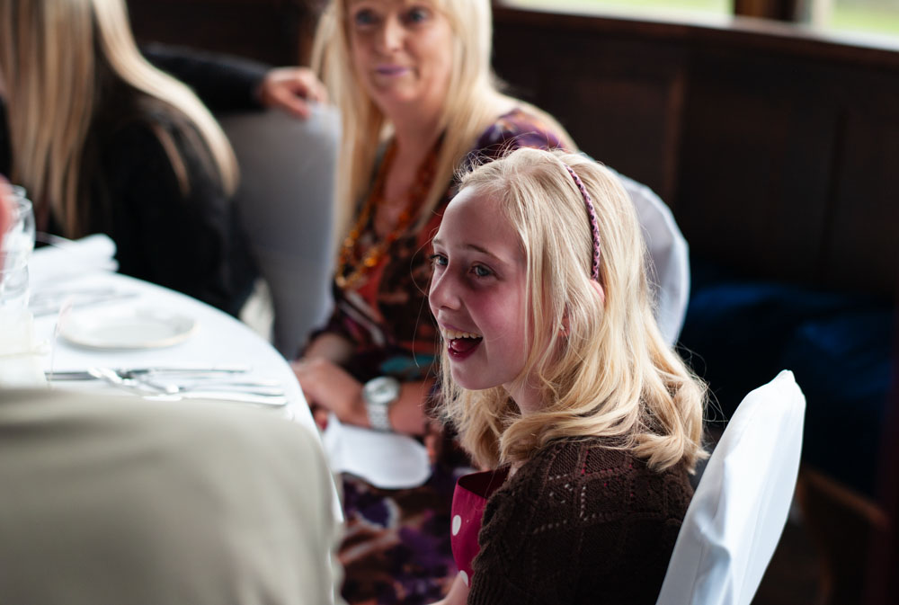 Girl smiling at the wedding breakfast table