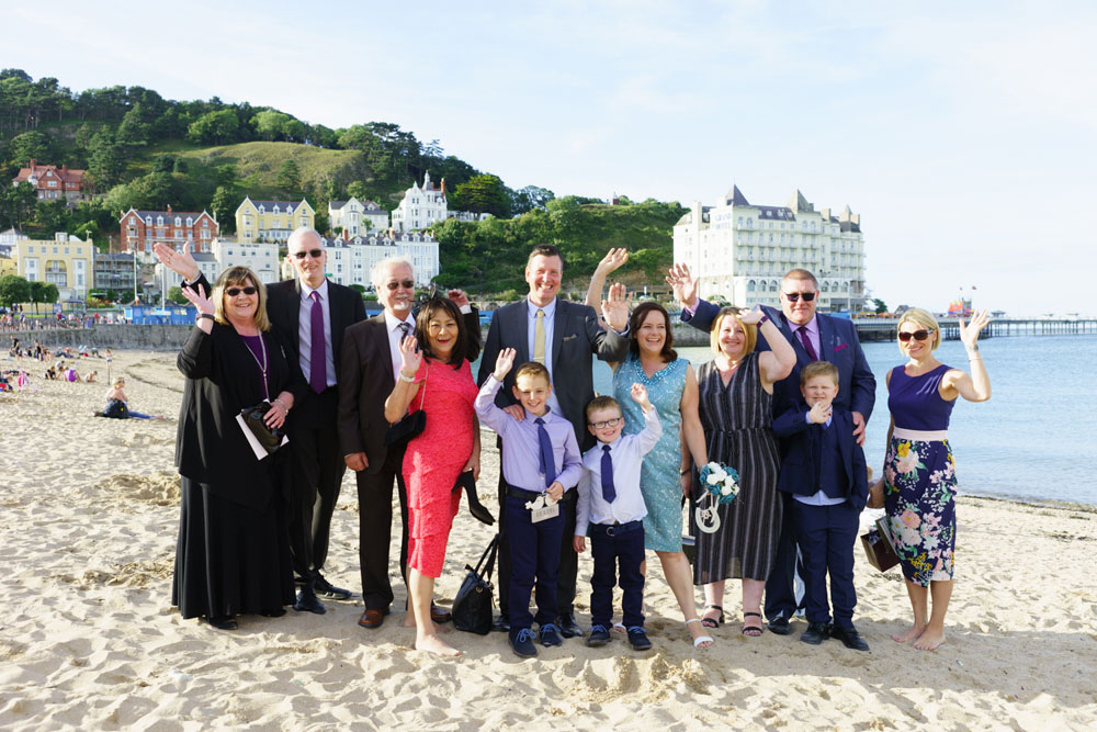 Larger family group photo on the beach by a wedding photographer West Yorkshire