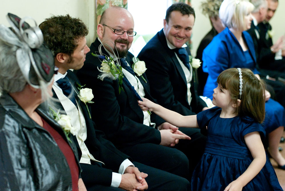 Flower girl with wand steals the moment inside the tiny church near SimonStone Hall.