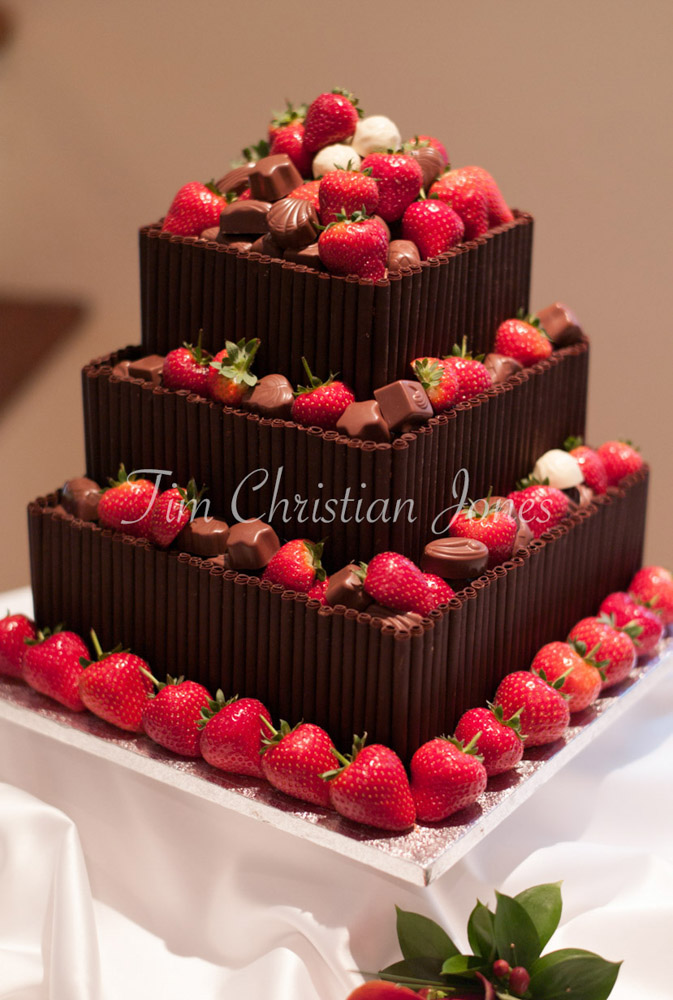 Close-up of the wedding cake — chocolate layers with fresh strawberries, beautifully simple.