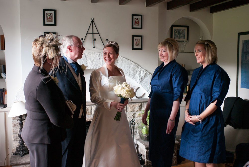 Gathered together - the bride and her parents and sisters - the bridesmaids happy smiles before the main event