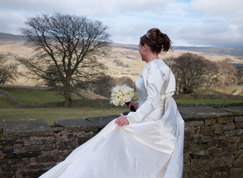 The views across the Yorkshire Dales - the bride in February light - her satin dress gleaming