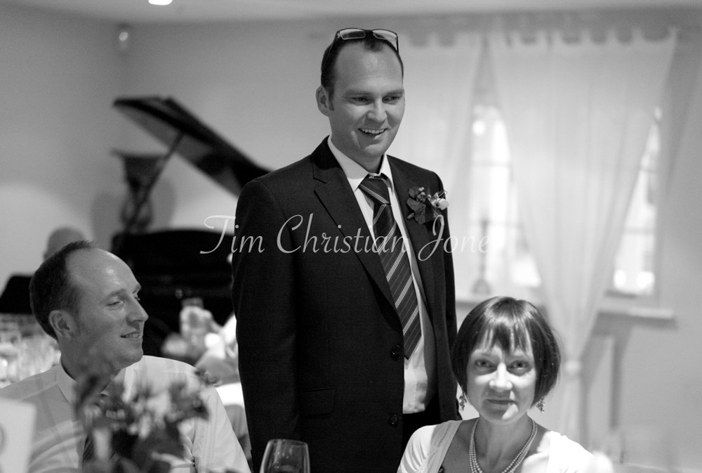 Pat walks the wedding breakfast tables, warmly greeting guests with easy charm.