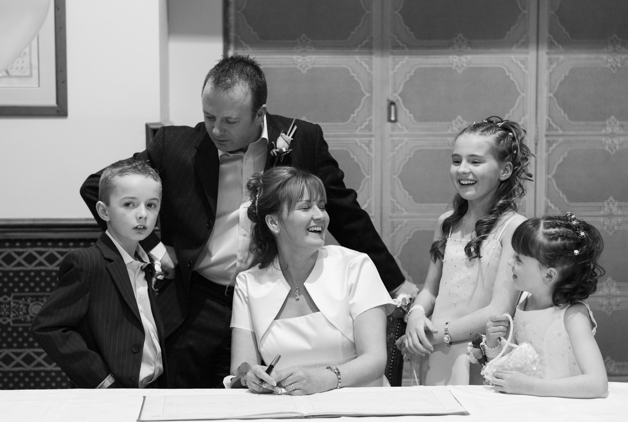 Family gathered candidly at the signing table