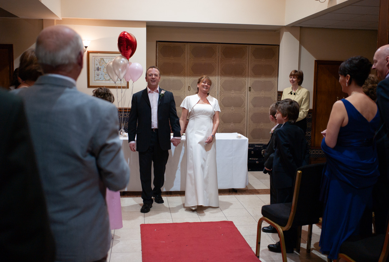 Couple beginning their exit from the ceremony room