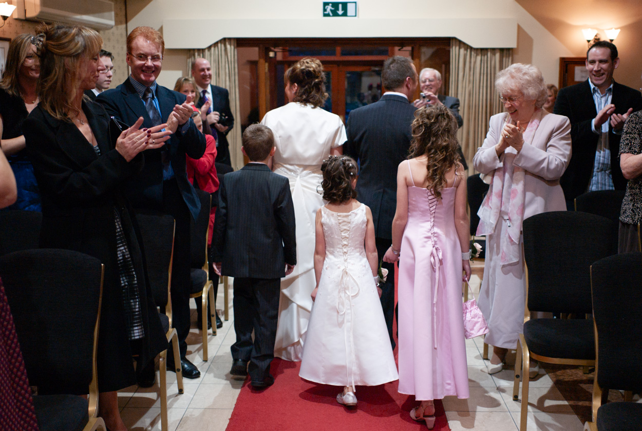 Guests applauding as the family exit