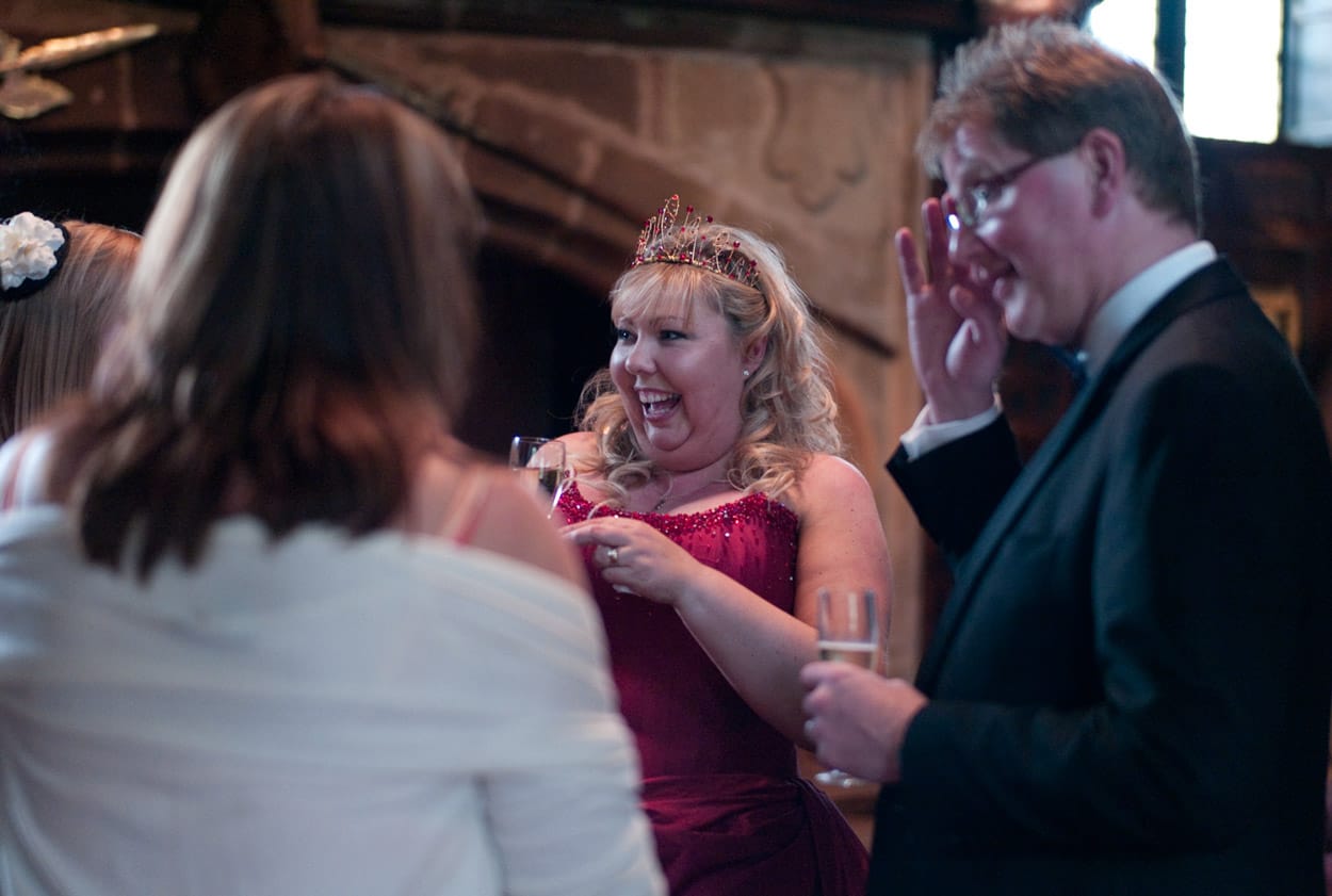 Nikki smiling widely, surrounded by friends during the afternoon reception.