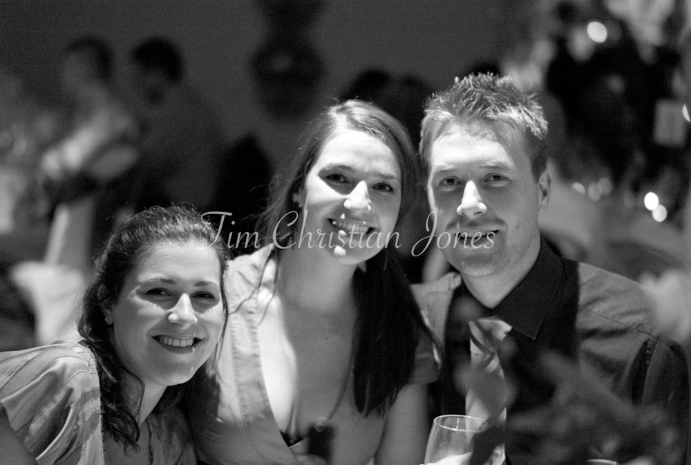 Wedding guests share laughter and stories during the meal, captured naturally.