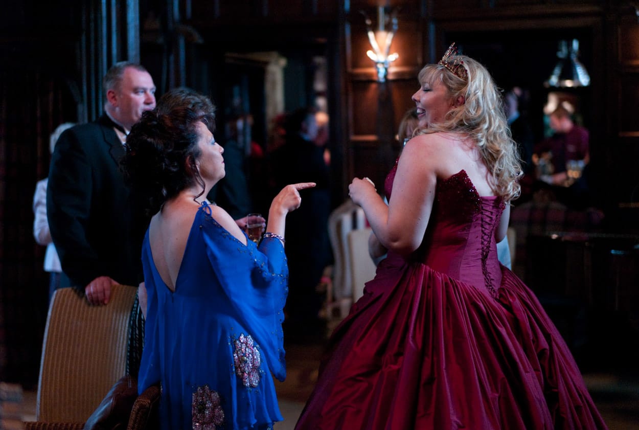 Nikki glowing in her red dress while greeting friends at Mitton Hall.