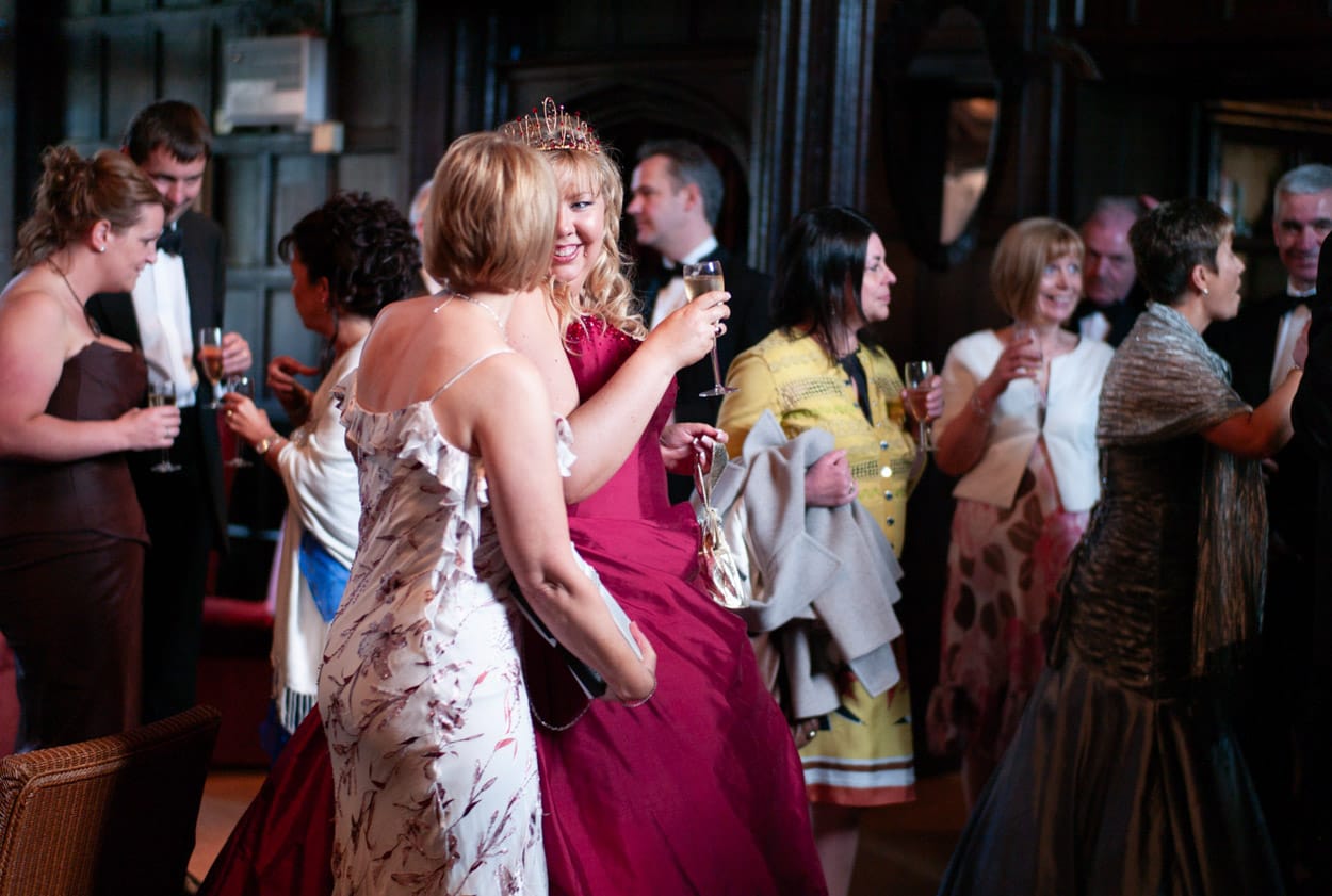 Nikki smiling surrounded by guests at the wedding breakfast.