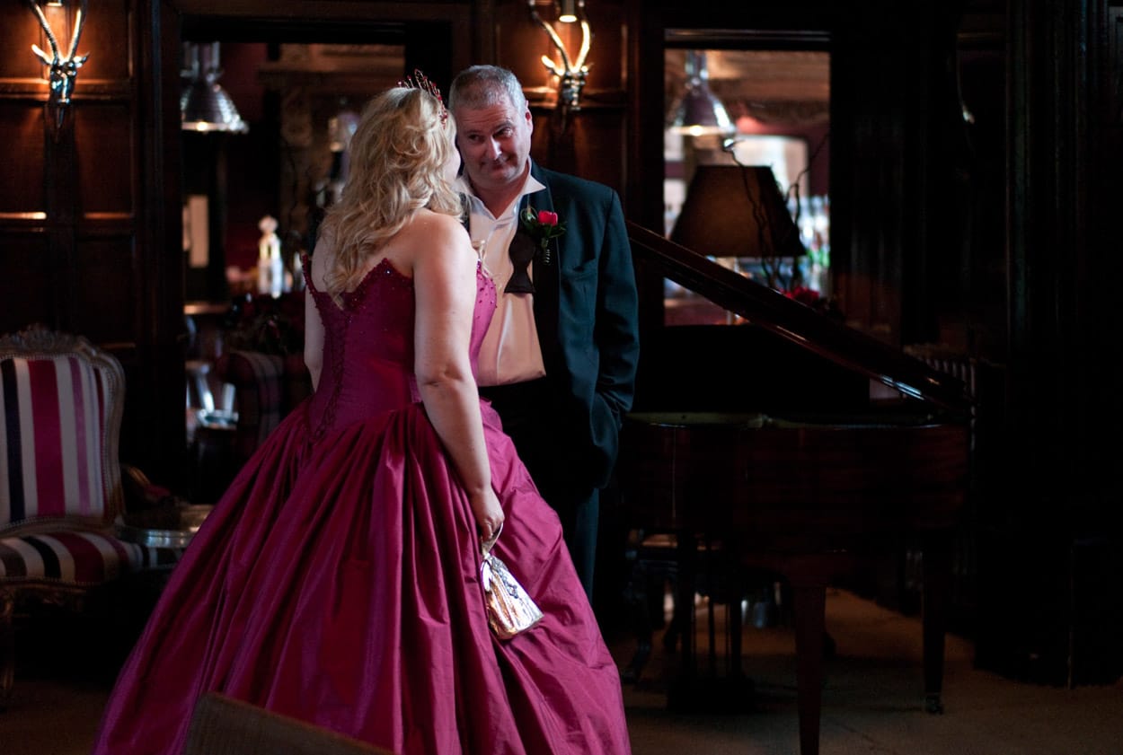 Natural unposed portrait of Nikki and Mike by the piano inside Mitton Hall.