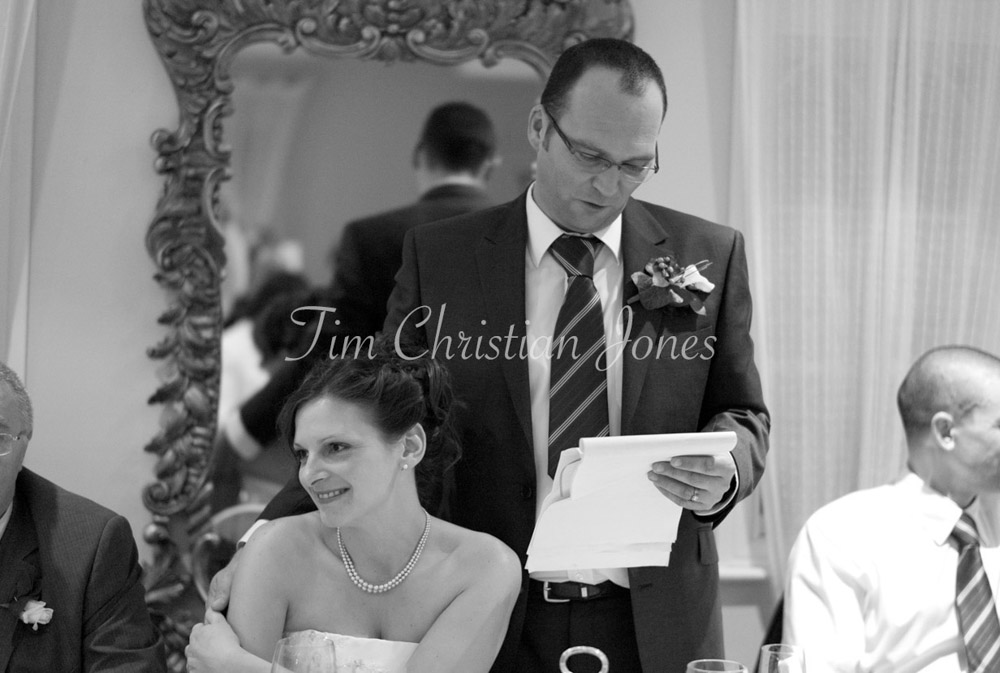 Pat speaks while Julie leans in beside him, their closeness unmistakable.