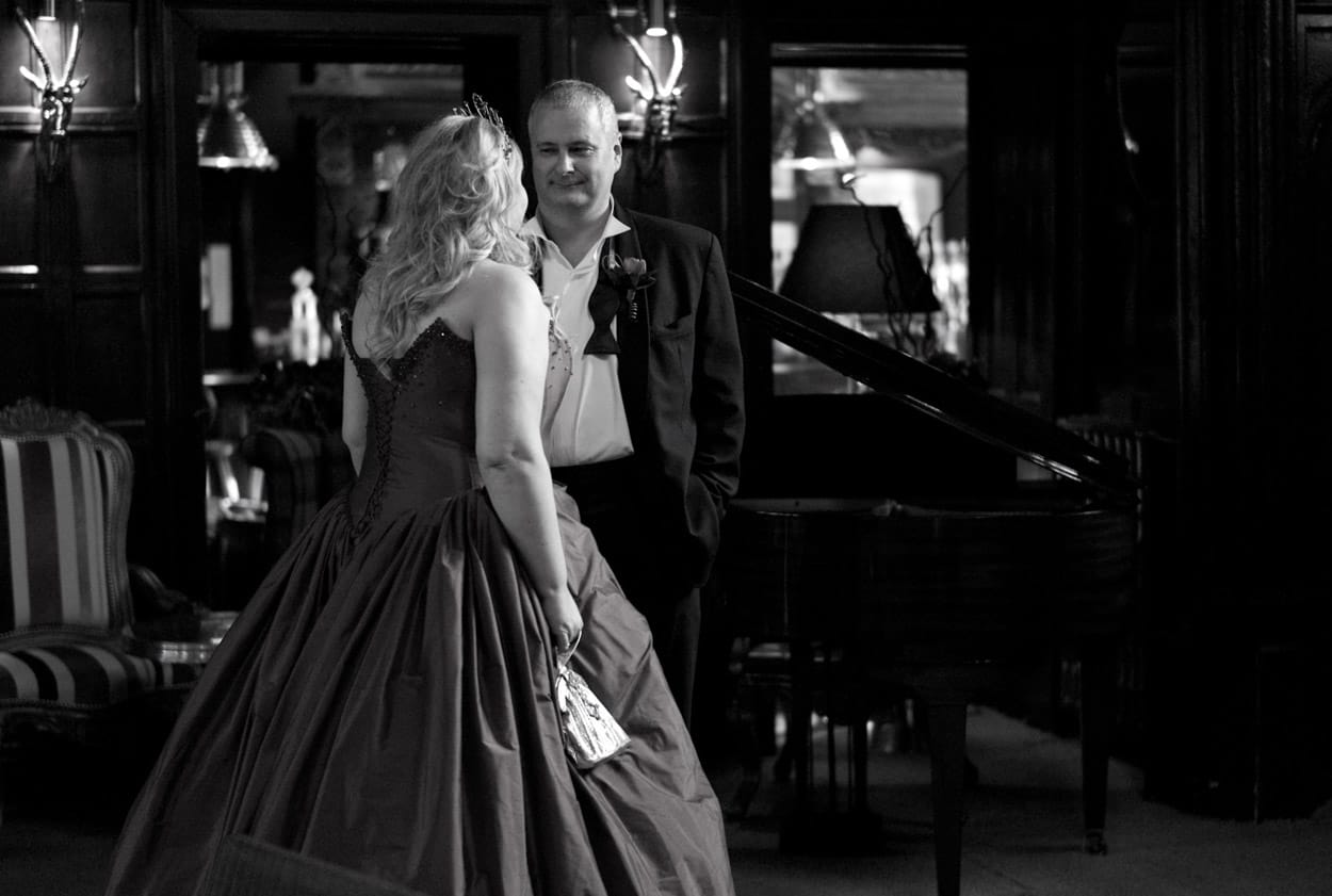 Black and white version of the couple’s portrait by the piano, Mike looking lovingly at Nikki.