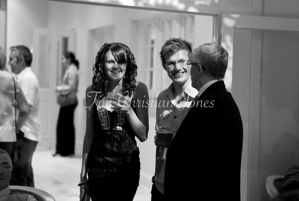 Guests share smiles and stories, relaxed in the warm evening atmosphere.