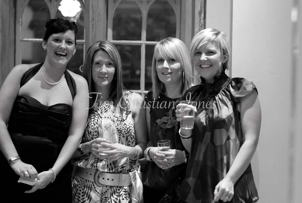 The bride’s sister laughs with three close friends in a candid group moment.