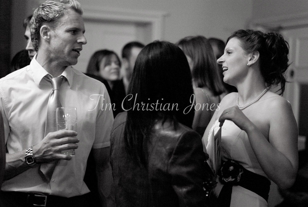 Julie moves through the crowd, chatting easily with evening guests.