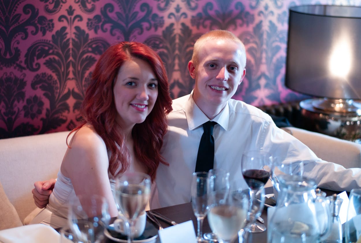 Young couple posing together for a table portrait.