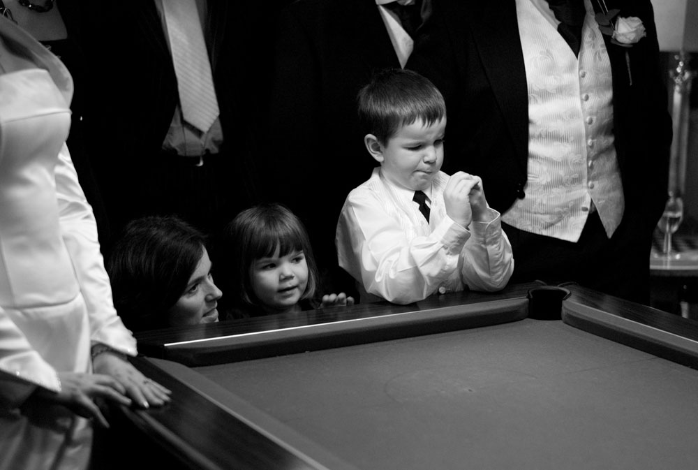 A close-up of the flower girl and pageboy, both lost in their own little daydreams.