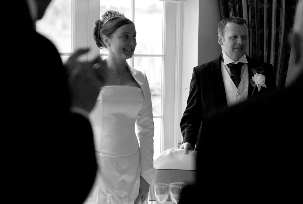The couple walk in together, ready to be seated for the wedding breakfast at Simonstone Hall.