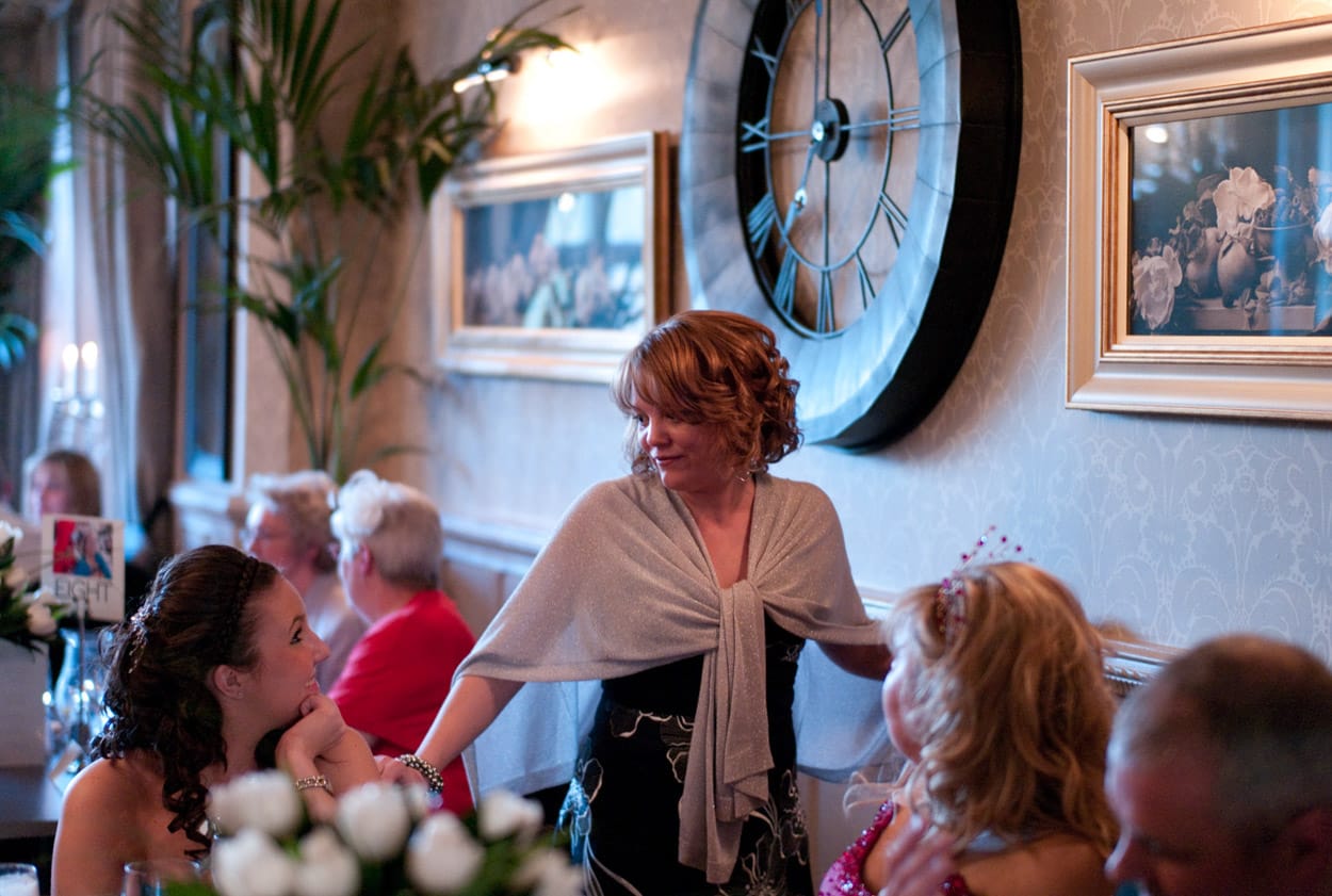 Guests mingling and chatting between tables during the speeches.