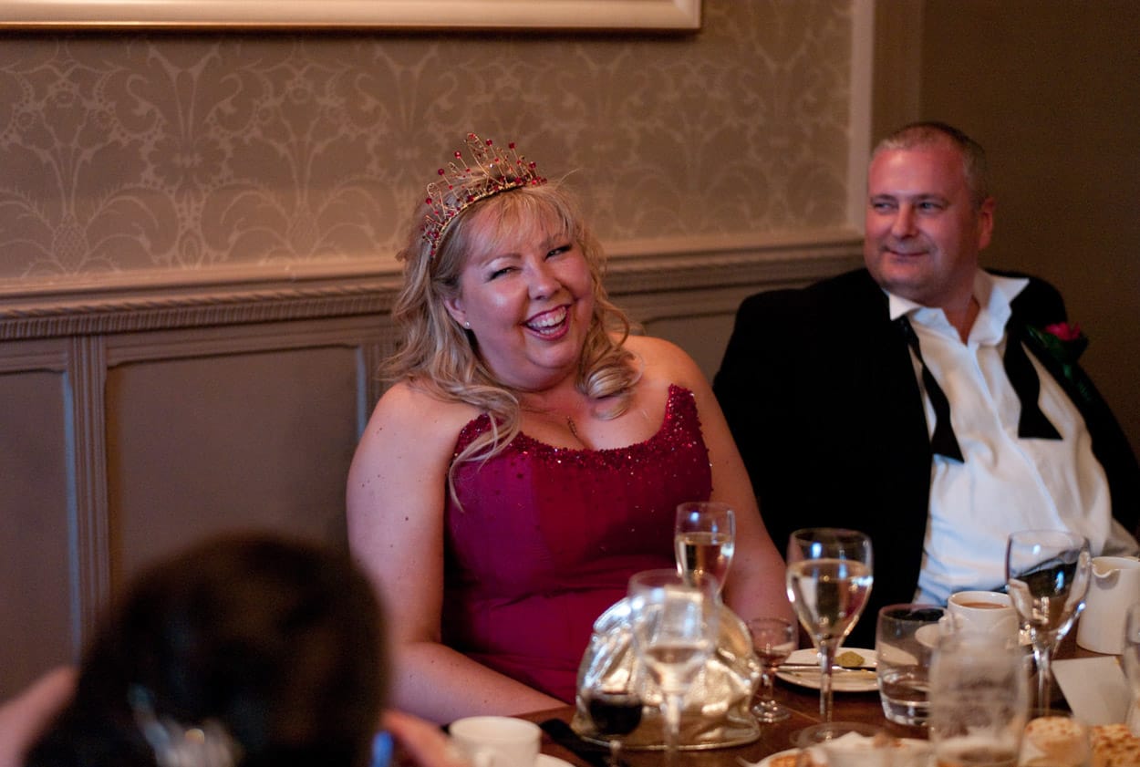 Nikki and Mike reacting with happiness to the Best Man’s speech.