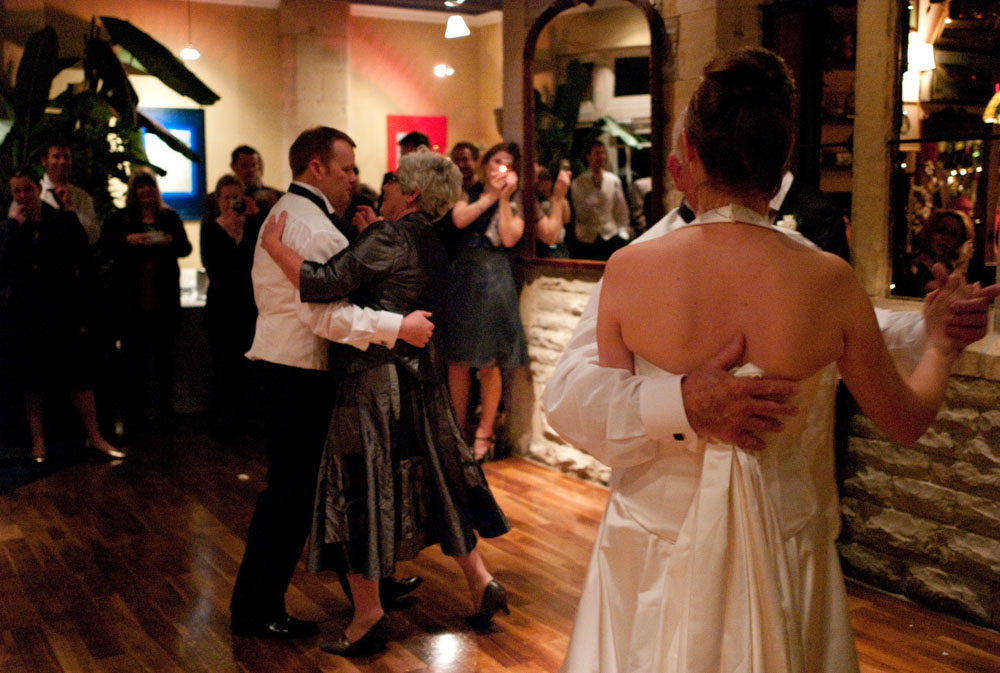 The newlyweds dance with their parents to begin the evening reception.