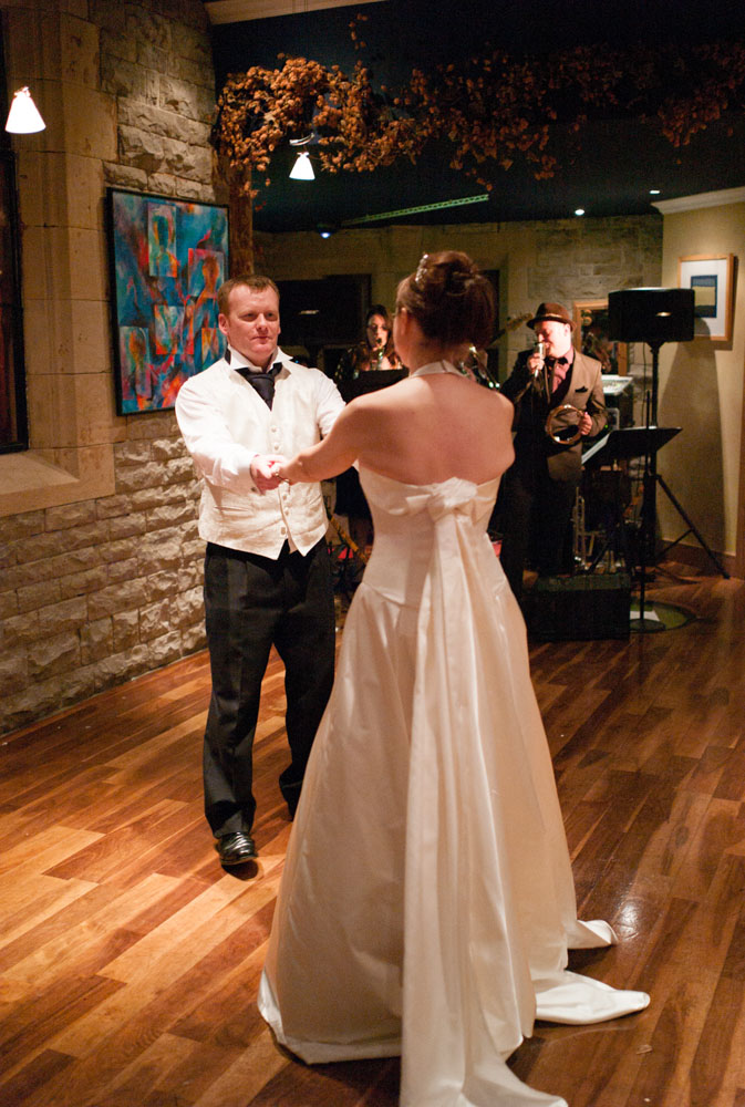 The couple dance with arms outstretched, holding hands and looking into each other's eyes.