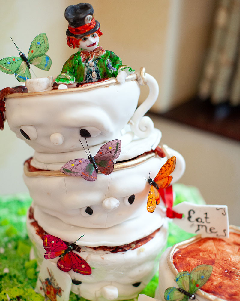 Mad Hatter themed wedding cake at Cartwright Hall wedding in Bradford, captured naturally by a Leeds wedding photographer before it began to droop