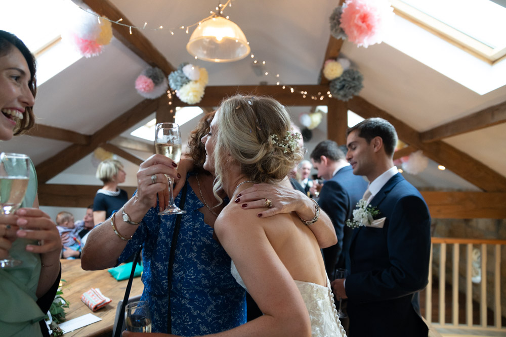 Bride hugs friends after the Chilli Barn wedding ceremony