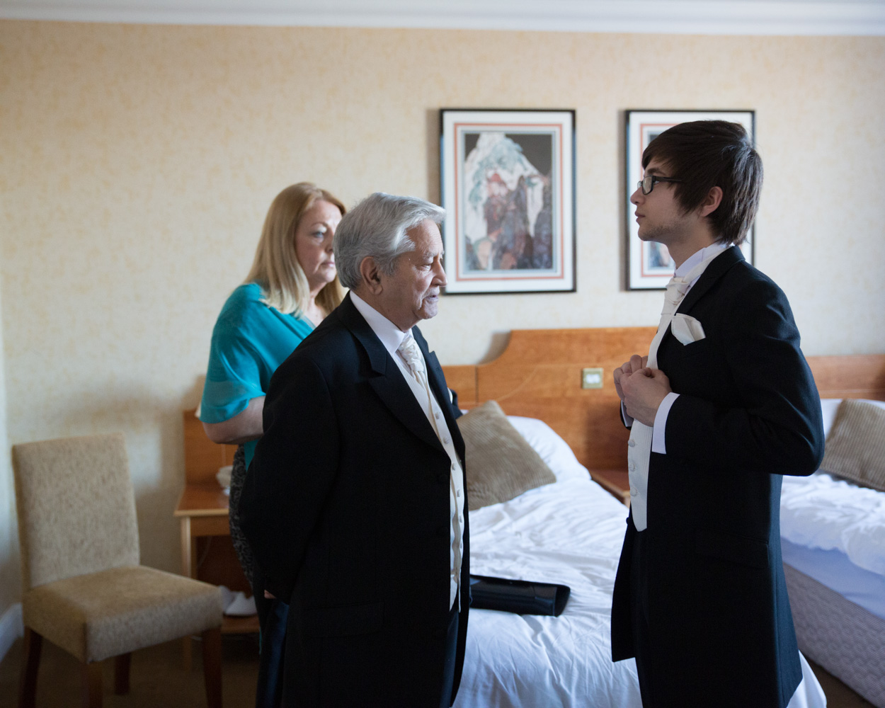 Zehra sits on the bed for final hair touches, calm and composed ahead of her Leeds wedding.