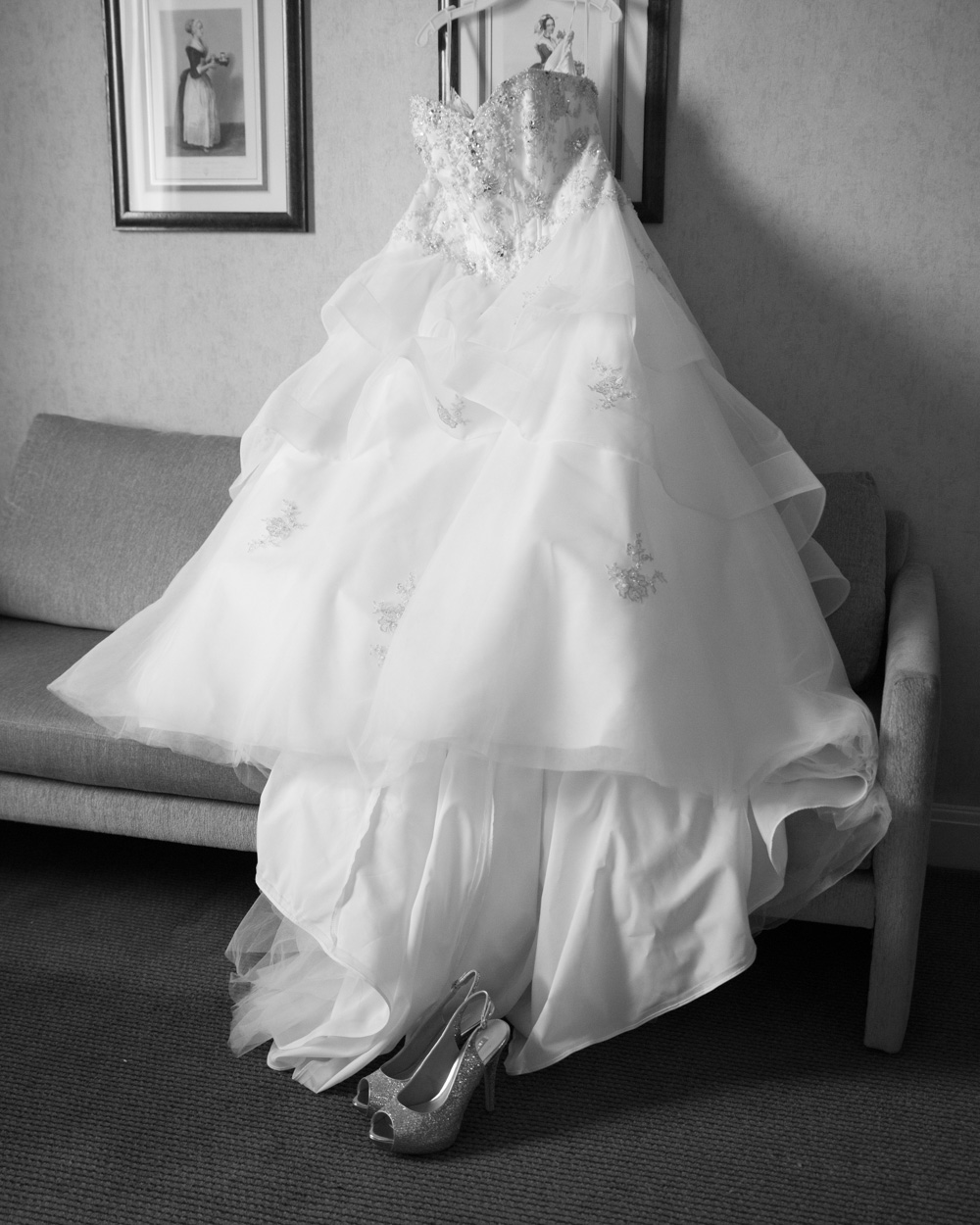 Natural candid moment of bridesmaids talking during bridal prep