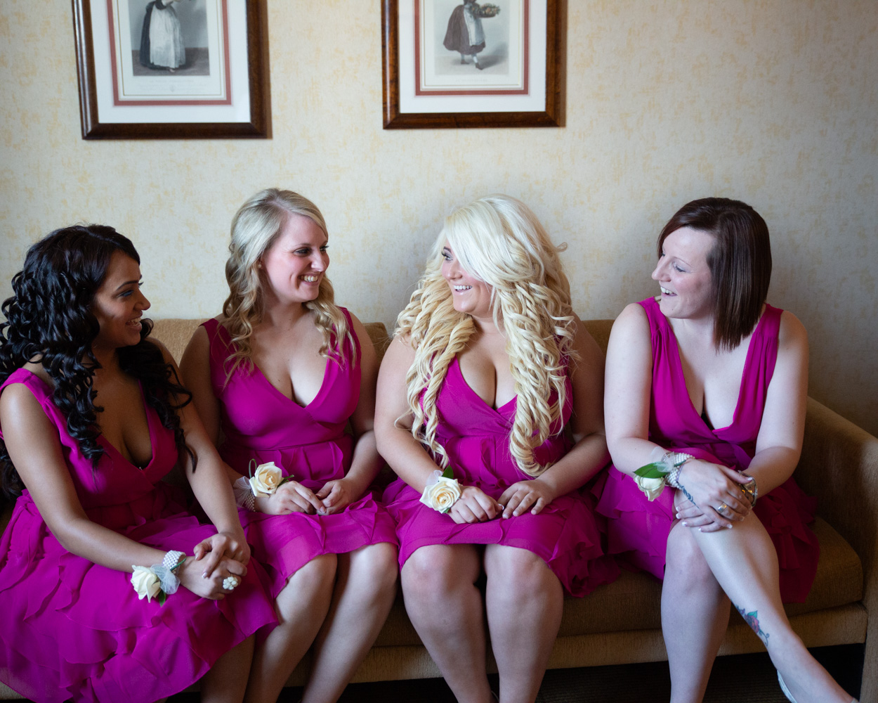 Zehra surrounded by her bridesmaids for final wedding dress adjustments