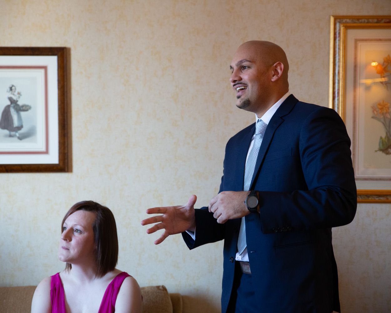 Groom’s father in conversation, seated, while Richard is out of frame