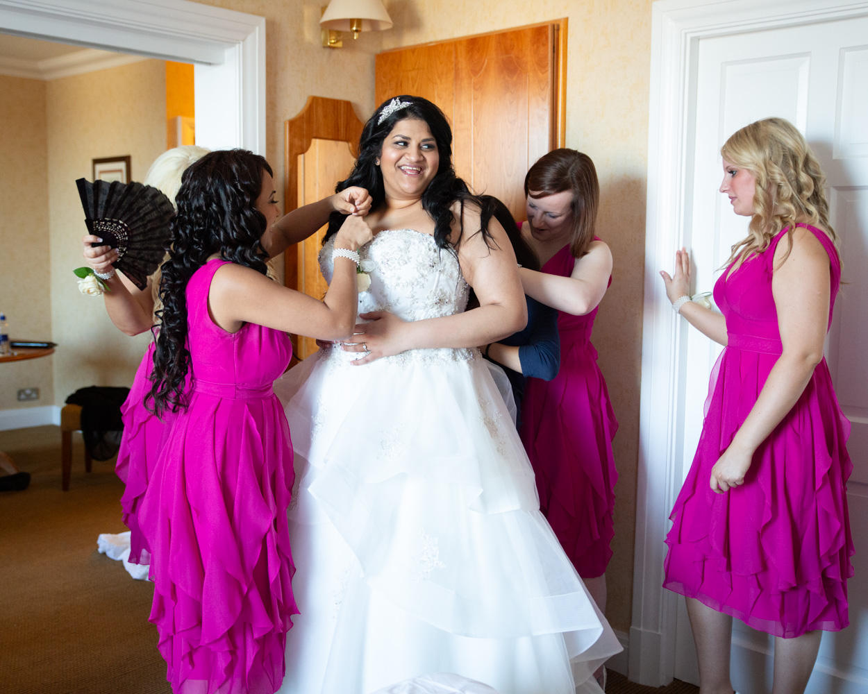 Bride and groom meet at the ceremony, father smiling as he takes his seat at Crowne Plaza Leeds