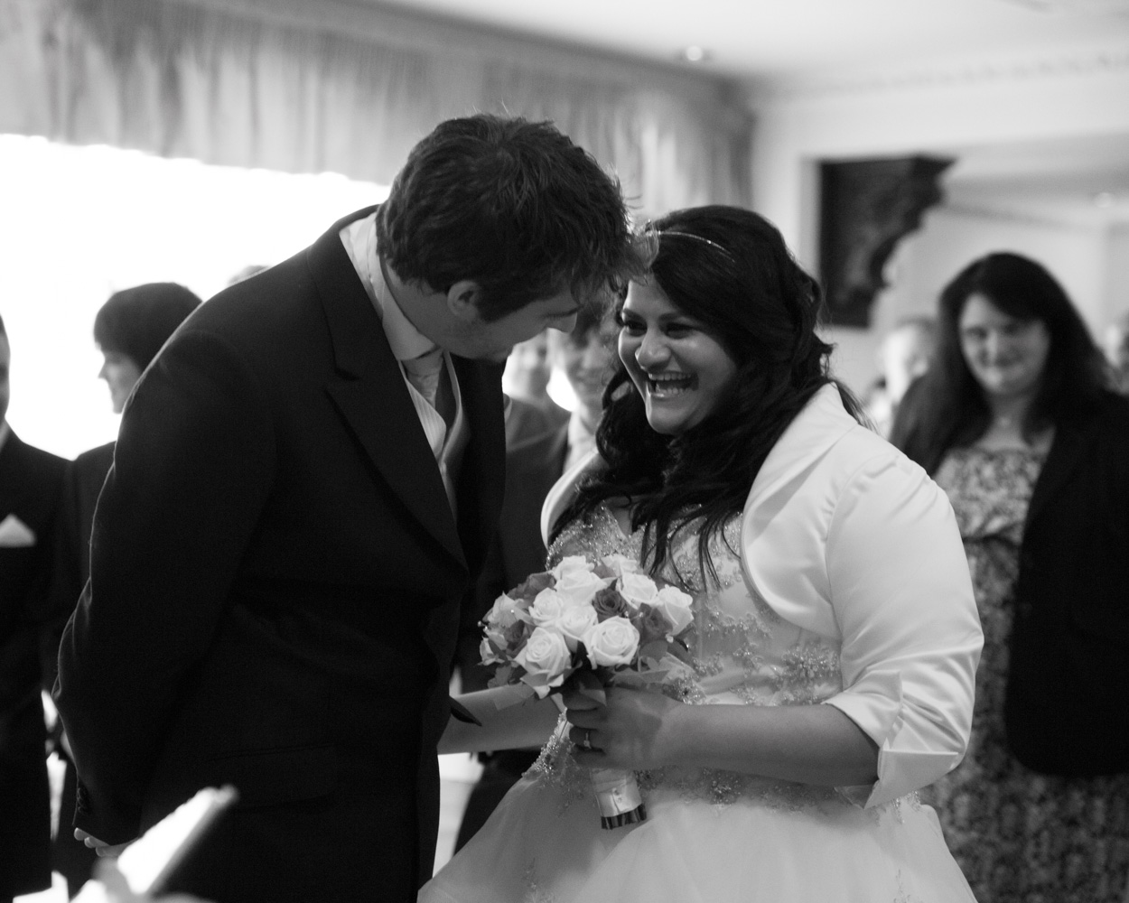 Bride and groom’s first kiss in black and white at Crowne Plaza Leeds ceremony
