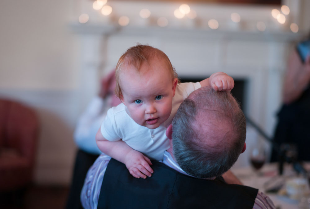 Cheeky moment as a little boy tugs at a bald man’s hair during the reception.