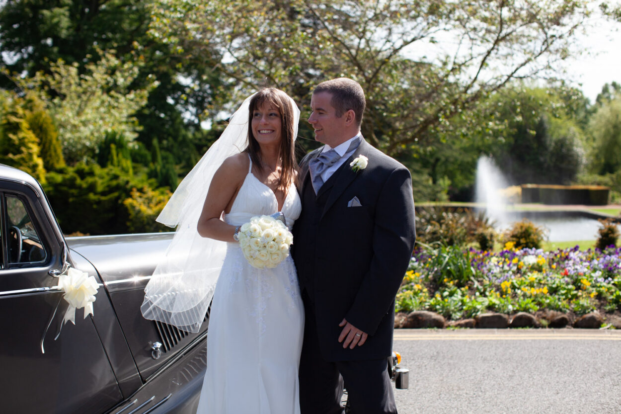 Bride and groom standing in soft natural light, framed with clean composition