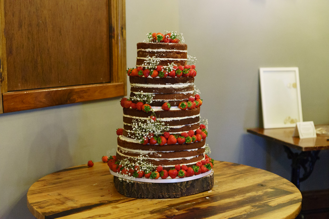 Naked wedding cake adorned with strawberries
