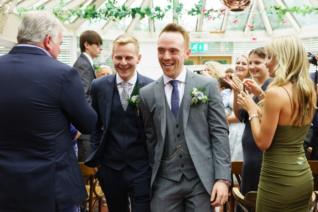 The Grooms exit the ceremony