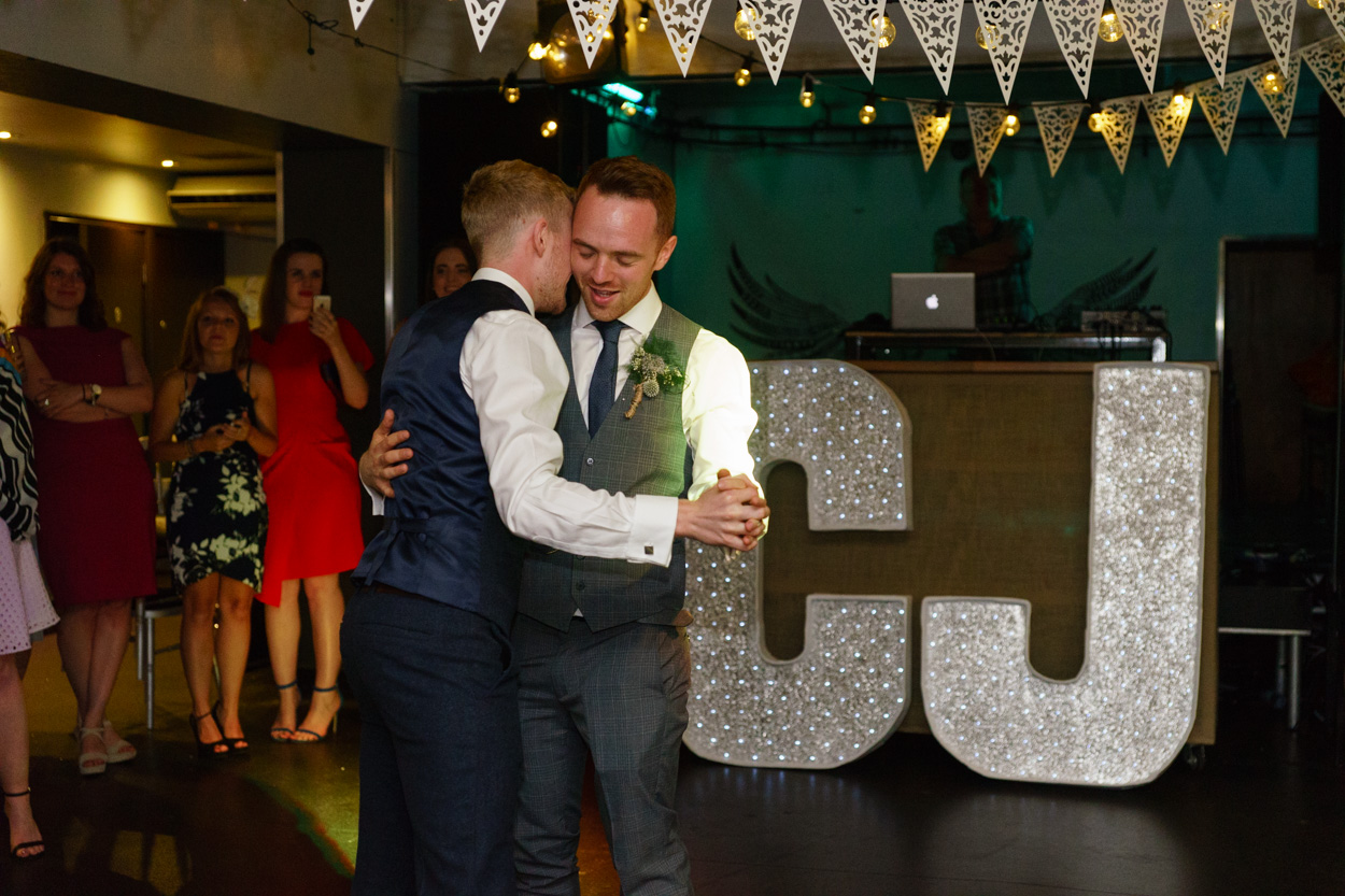 The first dance - Christian and Jason at The Faversham Leeds - C&J sign behind them