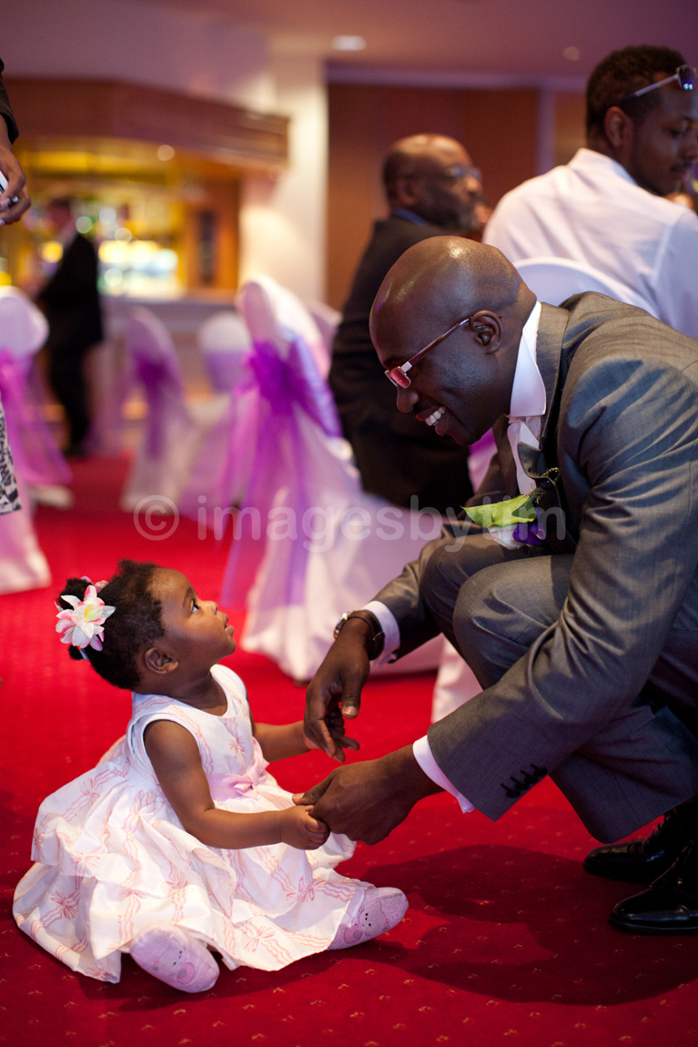 In the moment natural wedding moments - the groom knelt for the little bridesmaid. All images © Tim Christian Jones Photography