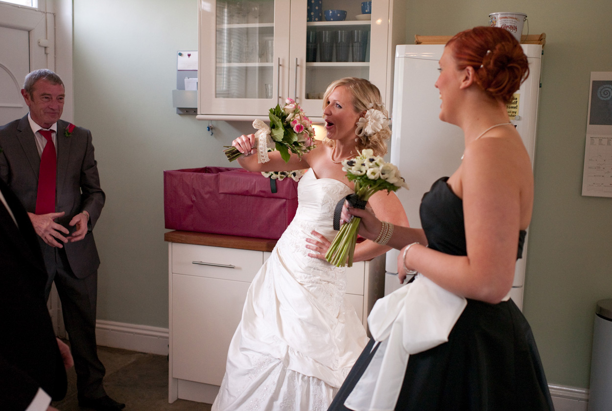 Second bridesmaid joins Dani in the kitchen, all smiles