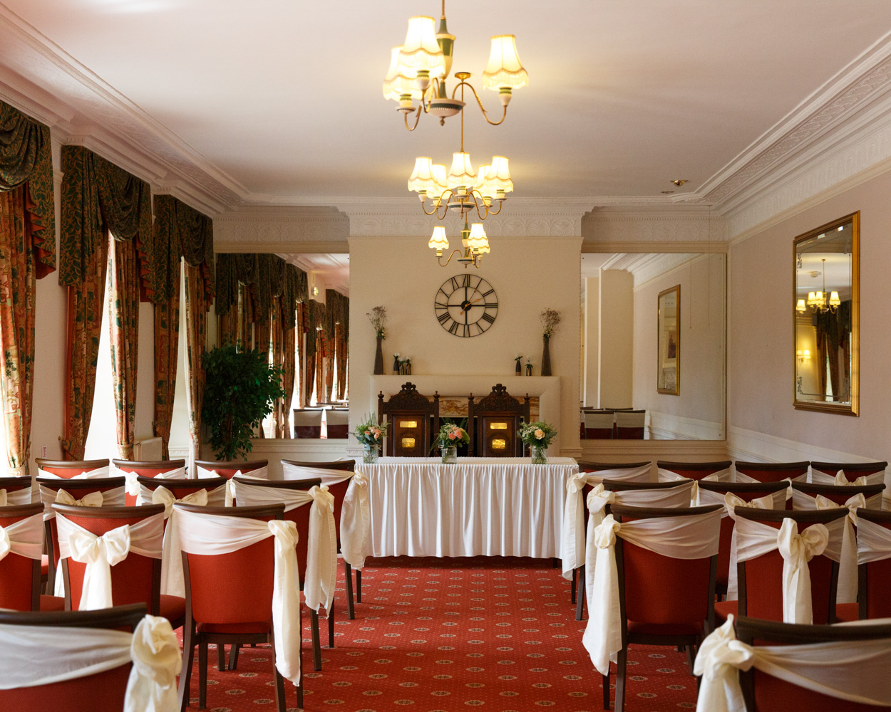 The ceremony room at Hoyle Court, Baildon - red and cream for a Summer wedding