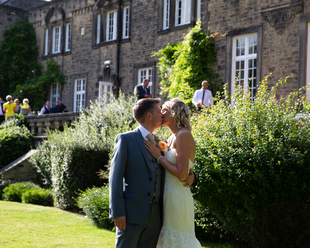 Couple portraits on the lawn in the sunshine at their Hoyle Court wedding
